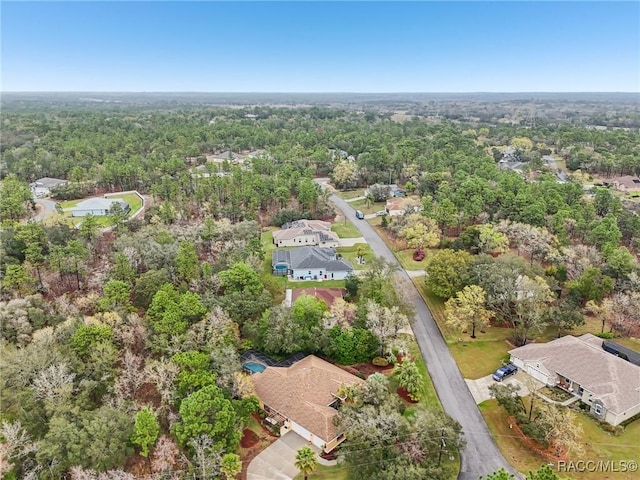 birds eye view of property with a view of trees