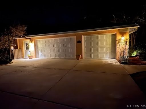 view of front of home with a garage and concrete driveway