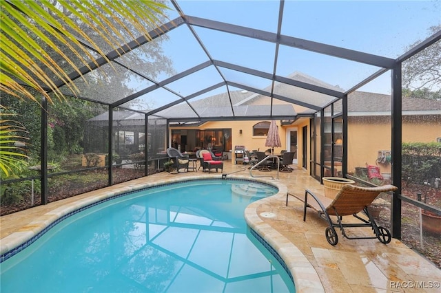 outdoor pool featuring a lanai and a patio area