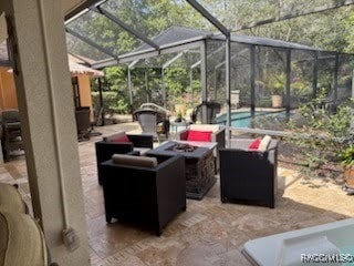 view of patio / terrace featuring a lanai, a fire pit, and an outdoor pool