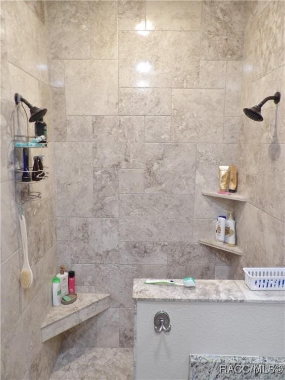 bathroom with tiled shower