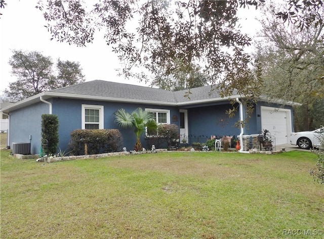 single story home with a garage, a front yard, and central AC