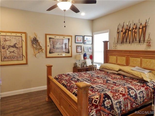 bedroom with dark hardwood / wood-style floors and ceiling fan