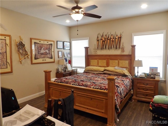 bedroom with dark hardwood / wood-style flooring and ceiling fan