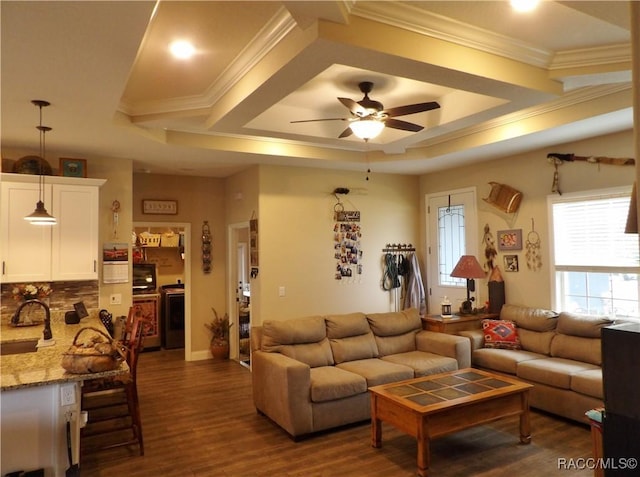 living room with ceiling fan, dark hardwood / wood-style floors, and ornamental molding