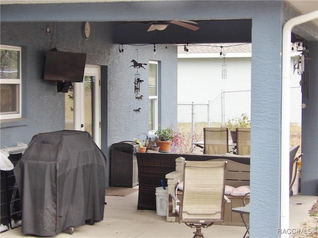 view of patio / terrace with ceiling fan and a grill