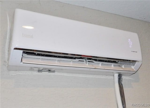 details featuring a wall mounted air conditioner