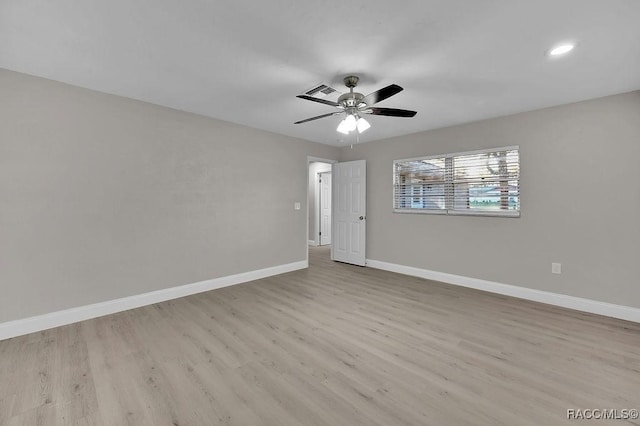 unfurnished room featuring visible vents, a ceiling fan, light wood-style flooring, and baseboards