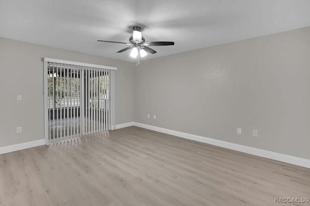 empty room featuring light wood-type flooring, a ceiling fan, and baseboards