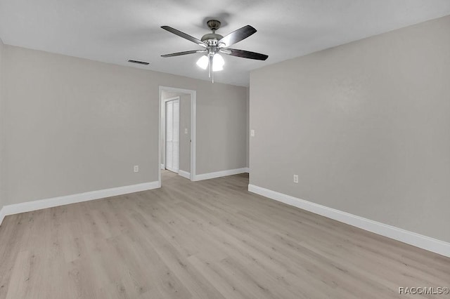 empty room with light wood-type flooring, baseboards, visible vents, and ceiling fan