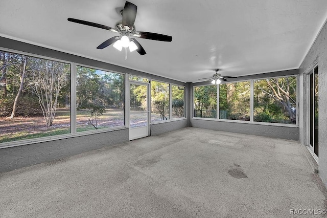 unfurnished sunroom featuring a ceiling fan