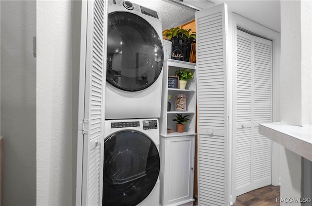 washroom with stacked washer / drying machine