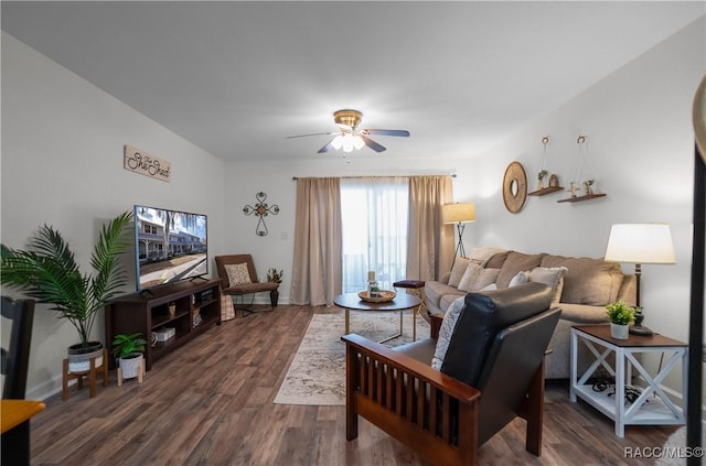 living room with dark hardwood / wood-style flooring and ceiling fan