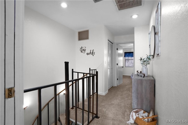 hallway with light colored carpet