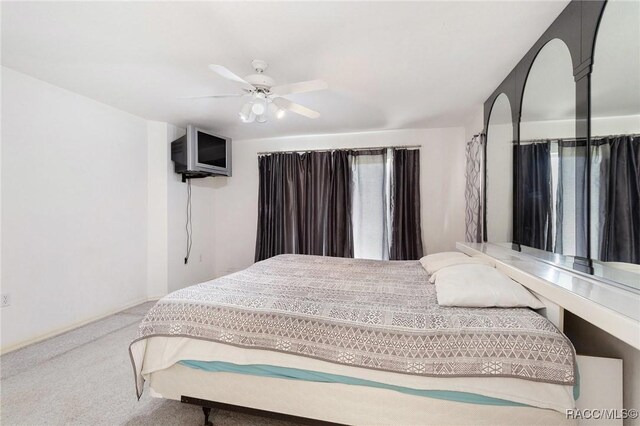 carpeted bedroom with baseboards and ceiling fan