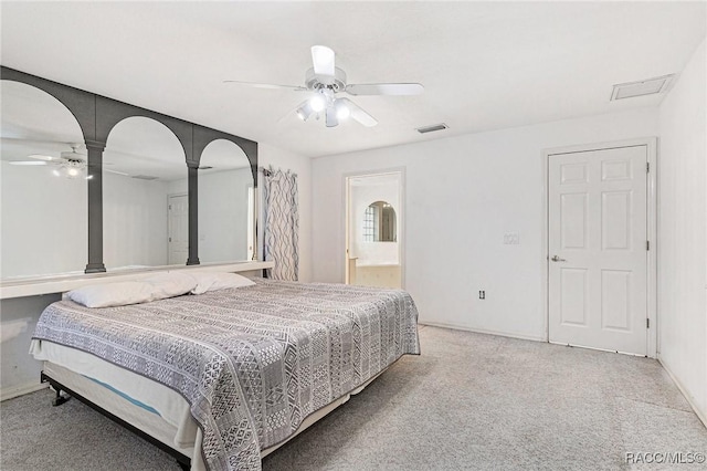 carpeted bedroom featuring connected bathroom, a ceiling fan, visible vents, and baseboards