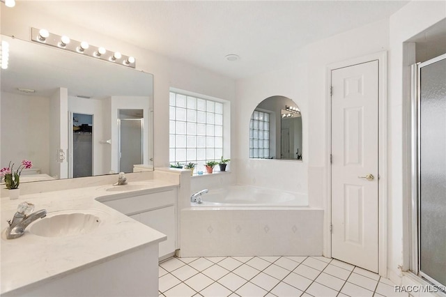 full bath featuring a shower stall, a closet, and a sink