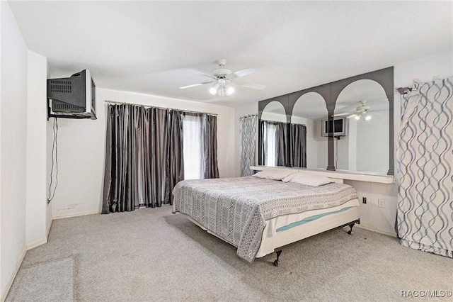 carpeted bedroom featuring a ceiling fan and baseboards