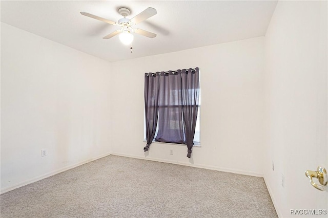 spare room with carpet flooring, baseboards, and ceiling fan