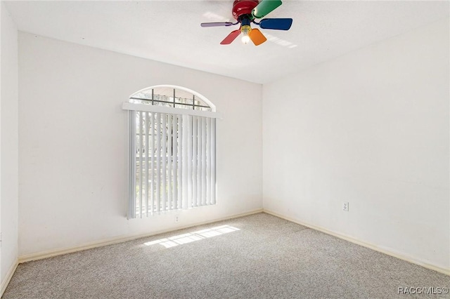 empty room featuring baseboards, a ceiling fan, and carpet floors