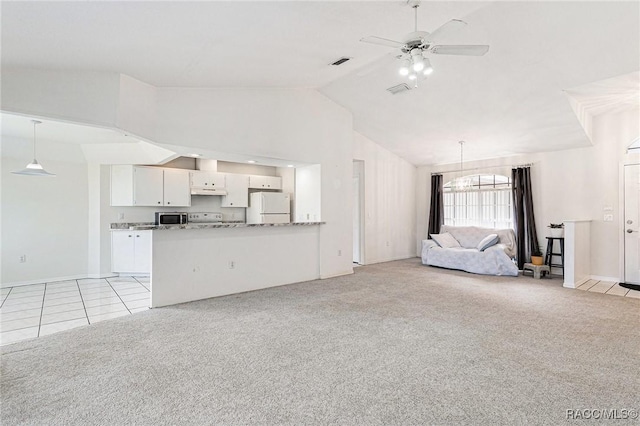 unfurnished living room with visible vents, light colored carpet, high vaulted ceiling, and ceiling fan with notable chandelier