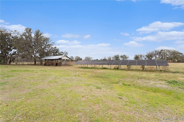 view of yard with an outbuilding and a rural view