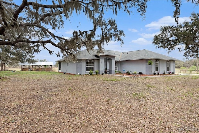 ranch-style house featuring stucco siding