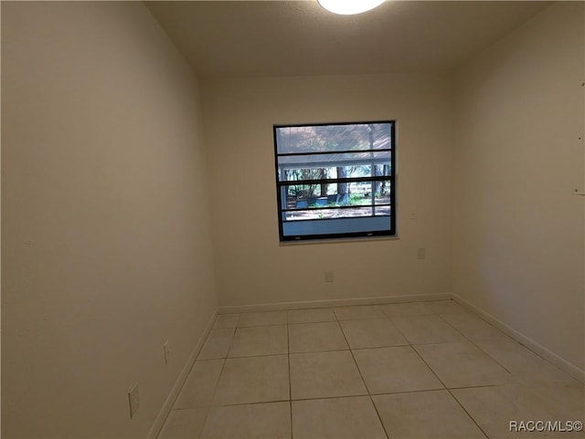 spare room featuring light tile patterned floors