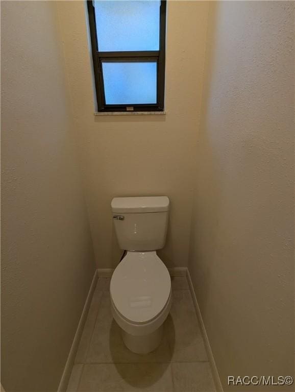 bathroom with tile patterned flooring and toilet
