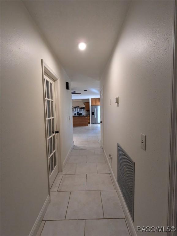 corridor featuring light tile patterned floors