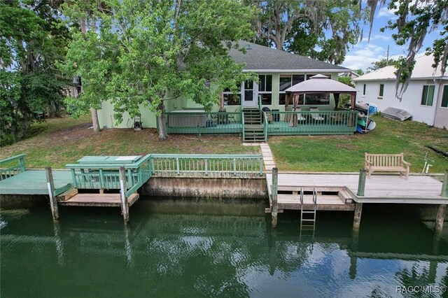 dock area featuring a lawn, a gazebo, and a deck with water view