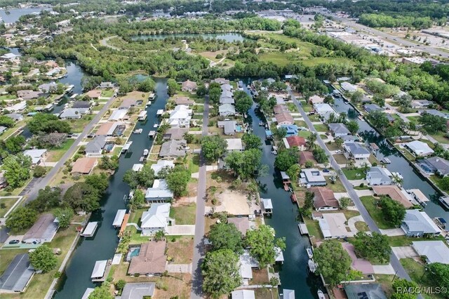 drone / aerial view featuring a water view and a residential view