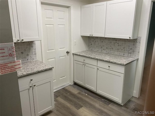45 S Davis St, Beverly Hills, FL 34465 - kitchen with dark wood-style flooring, white cabinets, decorative backsplash, and light stone countertops