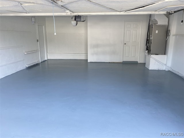 garage featuring heating unit and a garage door opener