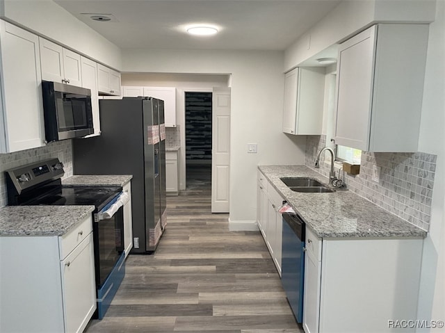 kitchen featuring white cabinets, sink, stainless steel appliances, and dark wood-type flooring