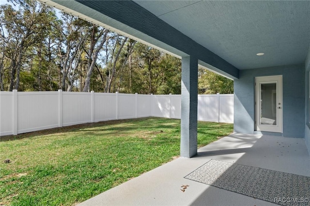 view of yard featuring a patio area and a fenced backyard