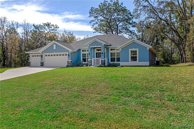 view of front facade with a front lawn, concrete driveway, roof with shingles, stucco siding, and a garage