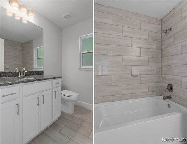 full bath featuring visible vents, toilet, baseboards, bathtub / shower combination, and vanity