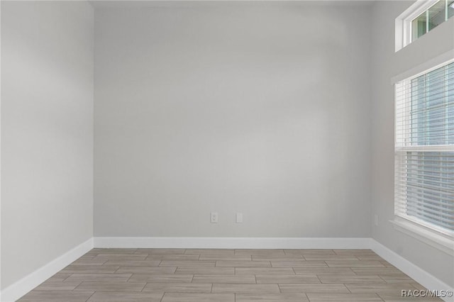 empty room featuring wood finish floors and baseboards