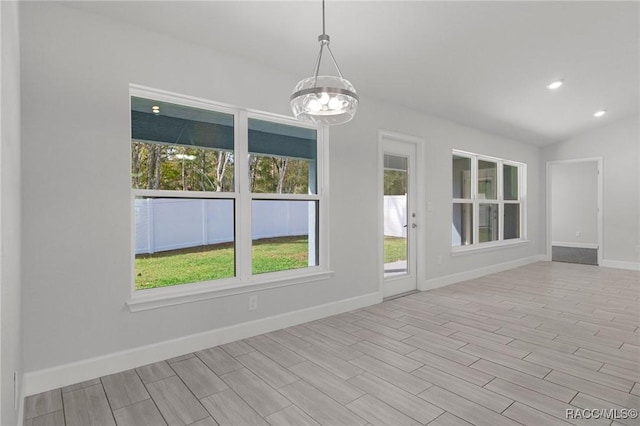 unfurnished sunroom featuring lofted ceiling and a notable chandelier