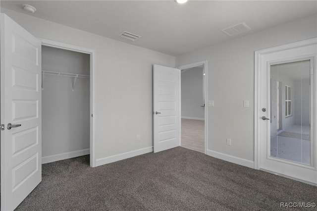 unfurnished bedroom with visible vents, carpet flooring, and baseboards