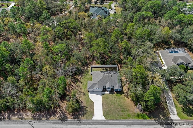 birds eye view of property featuring a view of trees