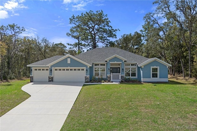 view of front of house with stucco siding, driveway, stone siding, a front yard, and a garage