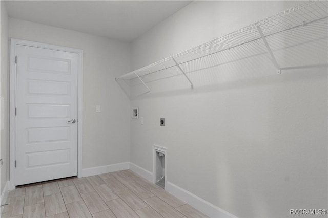 laundry room featuring wood finish floors, baseboards, washer hookup, laundry area, and electric dryer hookup