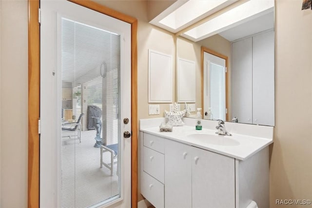 bathroom featuring vanity and a skylight