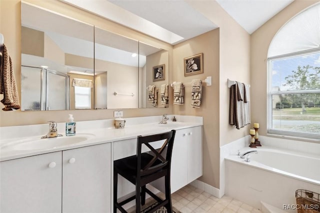 bathroom featuring tile patterned floors, vanity, separate shower and tub, and a skylight