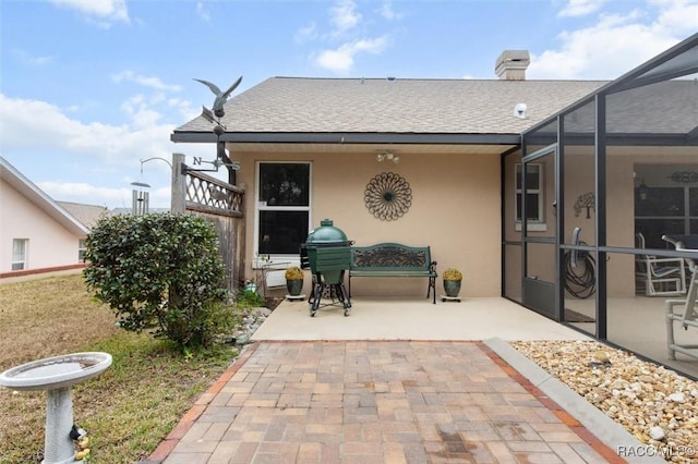 exterior space with a patio and glass enclosure