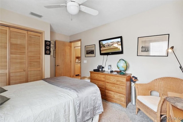 carpeted bedroom with a closet and ceiling fan