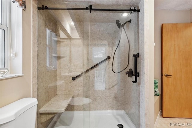 bathroom with toilet and an enclosed shower