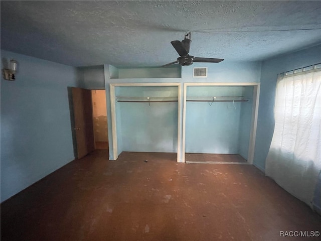 120 NW Magnolia Cir, Crystal River, FL 34428 - unfurnished bedroom with multiple closets, a textured ceiling, and ceiling fan